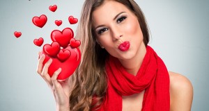 Attractive smiling woman with red heart