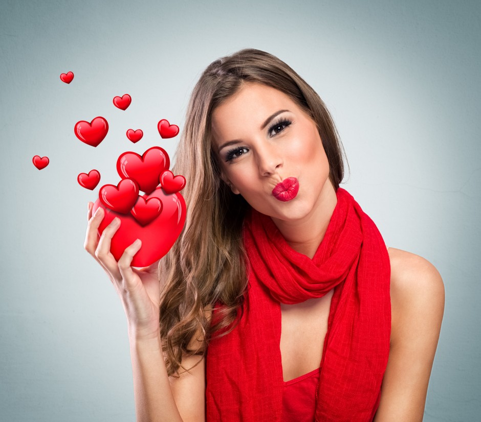 Attractive smiling woman with red heart