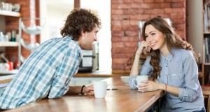 Young couple enjoying coffee in cafeteria
